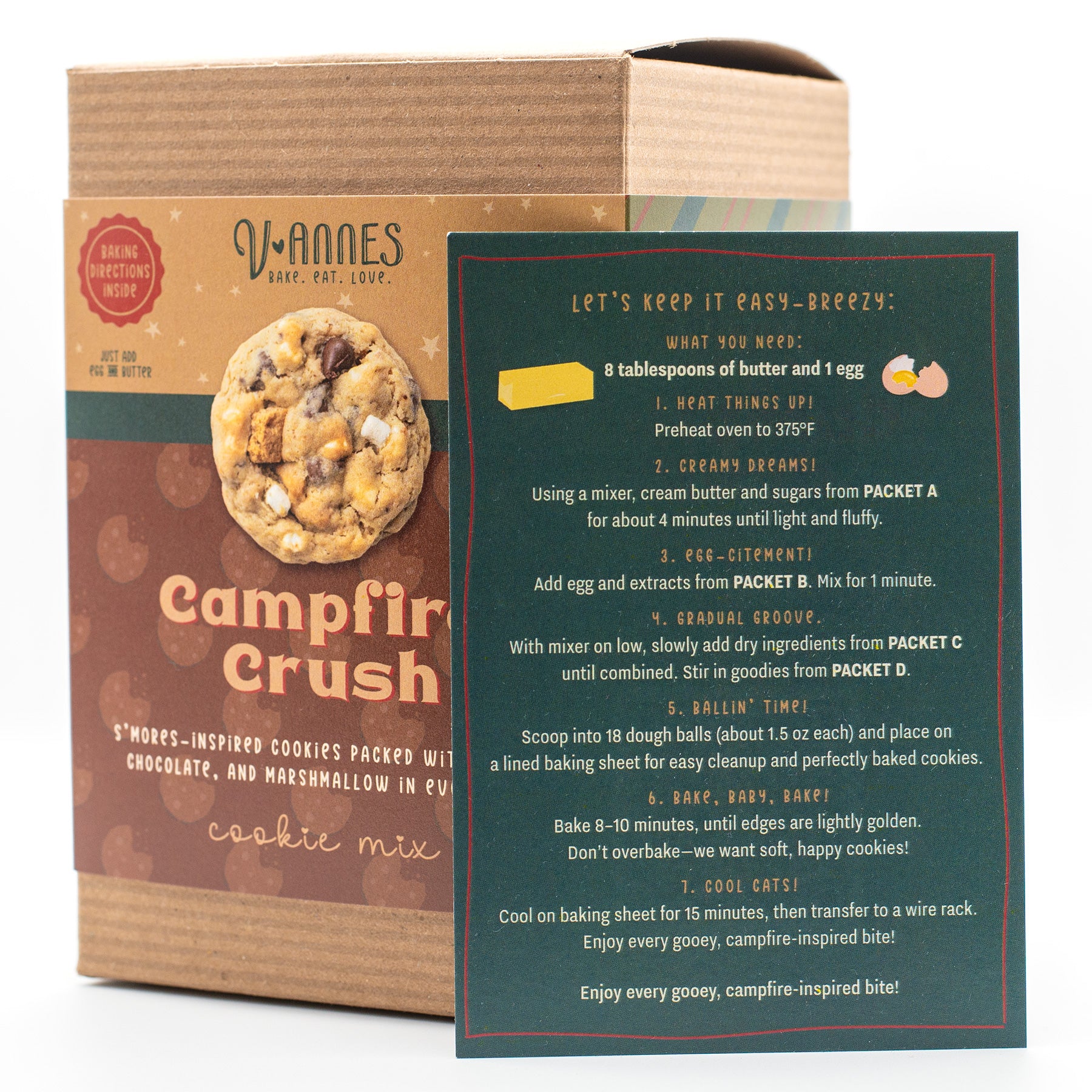 V-Annes Campfire Crush cookie mix packaging shown with a brown cardboard box and a dark green recipe card featuring handwritten-style instructions and cookie illustrations.